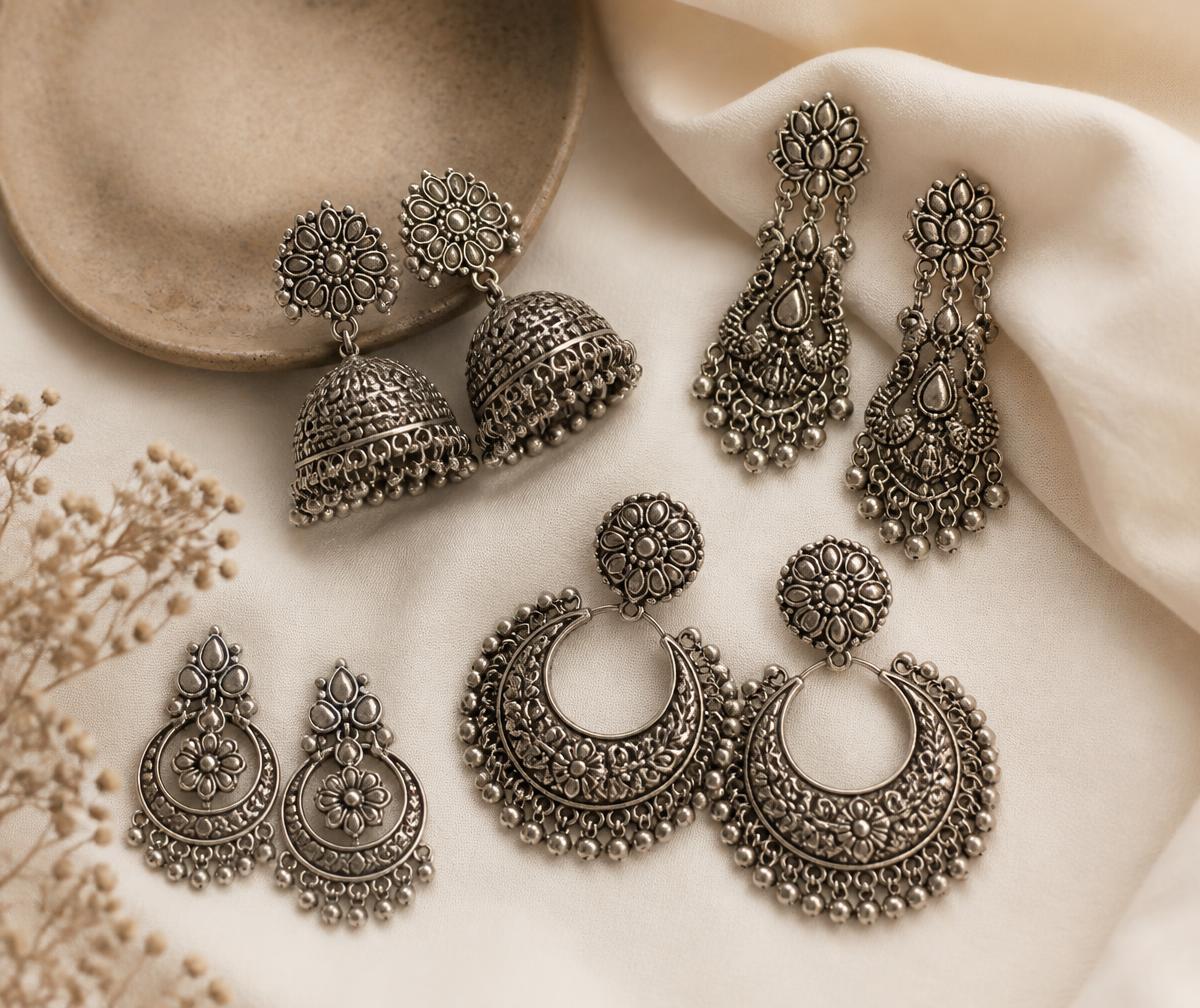 Indian oxidised silver jhumkas and ethnic danglers on cream fabric